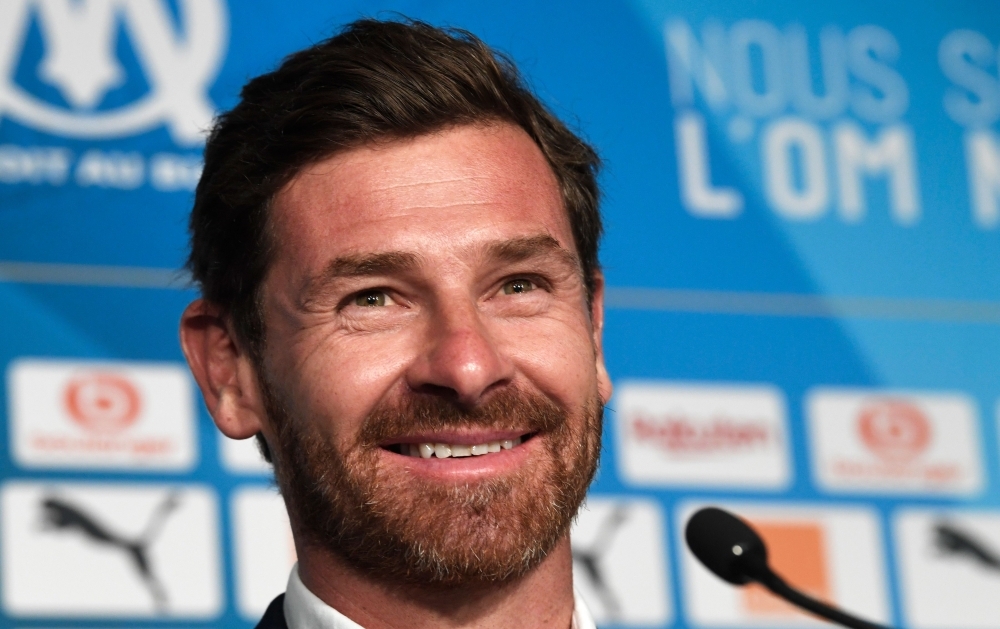 Olympique de Marseille's new coach Portuguese Andre Villas-Boas poses with a team jersey with the club's president Jacques-Henri Eyraud and sport director Andoni Zubizarreta during his official presentation to the press on Wednesday at the Velodrome stadium in Marseille. — AFP
