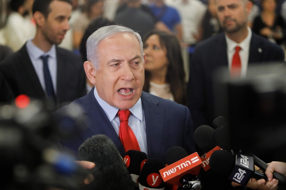 Israeli Prime Minister Benjamin Netanyahu talks to the press following a vote on a bill to dissolve the Knesset (Israeli parliament) in Jerusalem on Wednesday. — AFP