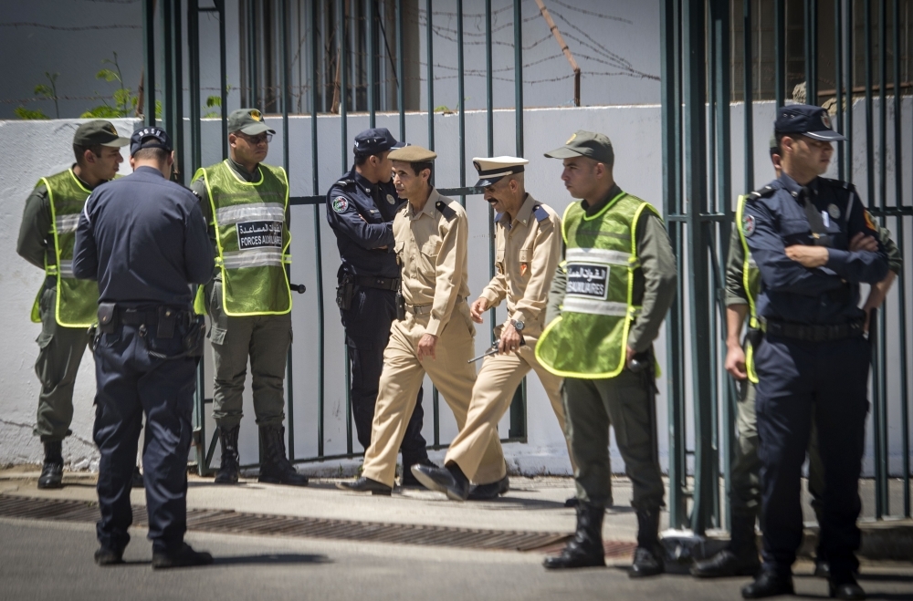 Members of the Moroccan security forces stand guard during the trial of militant suspects charged over the brutal murder of two Scandinavian women hiking in Morocco, at a court in Sale, near the capital Rabat, on Thursday. — AFP