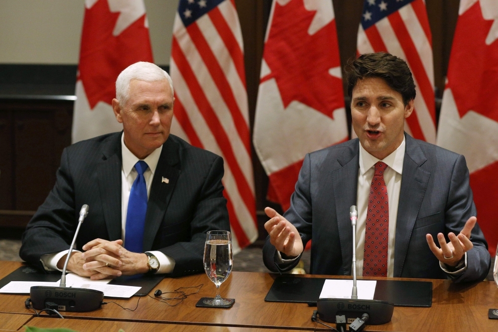 US Vice President Mike Pence and Canadian Prime minister Justin Trudeau attend a meeting with the Canadian Council for the US-Mexico-Canada Agreement in Ottawa, Ontario, on Thursday. — AFP