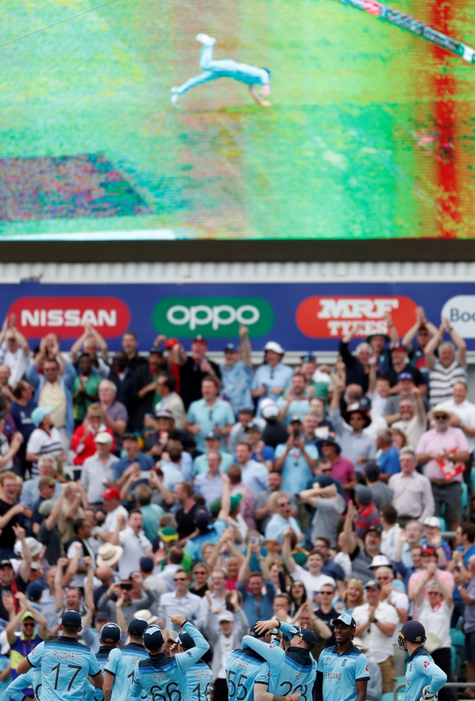 England players and fans celebrate the wicket of South Africa's Andile Phehlukwayo as England's Ben Stokes in seen on the big screen taking the catch during the ICC Cricket World Cupmatch at the Kia Oval, London, Britain, on Thursday. — Reuters