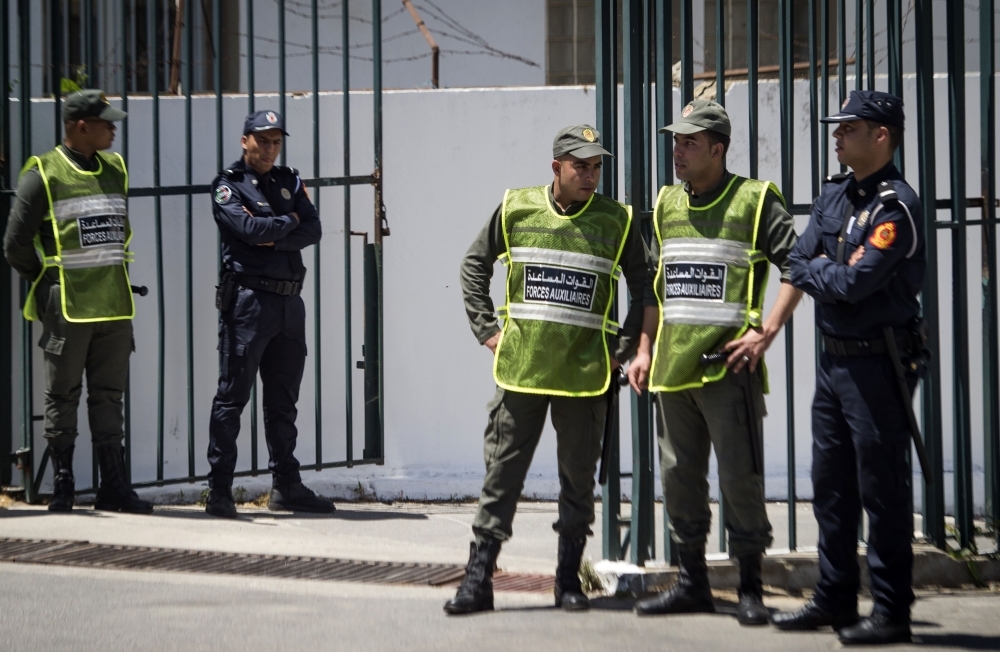 Members of the Moroccan security forces stand guard during the trial of militant suspects charged over the brutal murder of two Scandinavian women hiking in Morocco, at a court in Sale, near the capital Rabat, on Thursday. — AFP