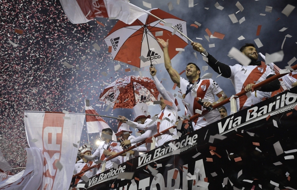 Argentina's River Plate footballers receive the trophy from CONMEBOL's President, Alejandro Dominguez (L-bottom) after winning the 2019 Recopa Sudamericana football final match against Brazil's Athletico Paranaense at the Monumental stadium, in Buenos Aires on Thursday. River won 3-0. — AFP