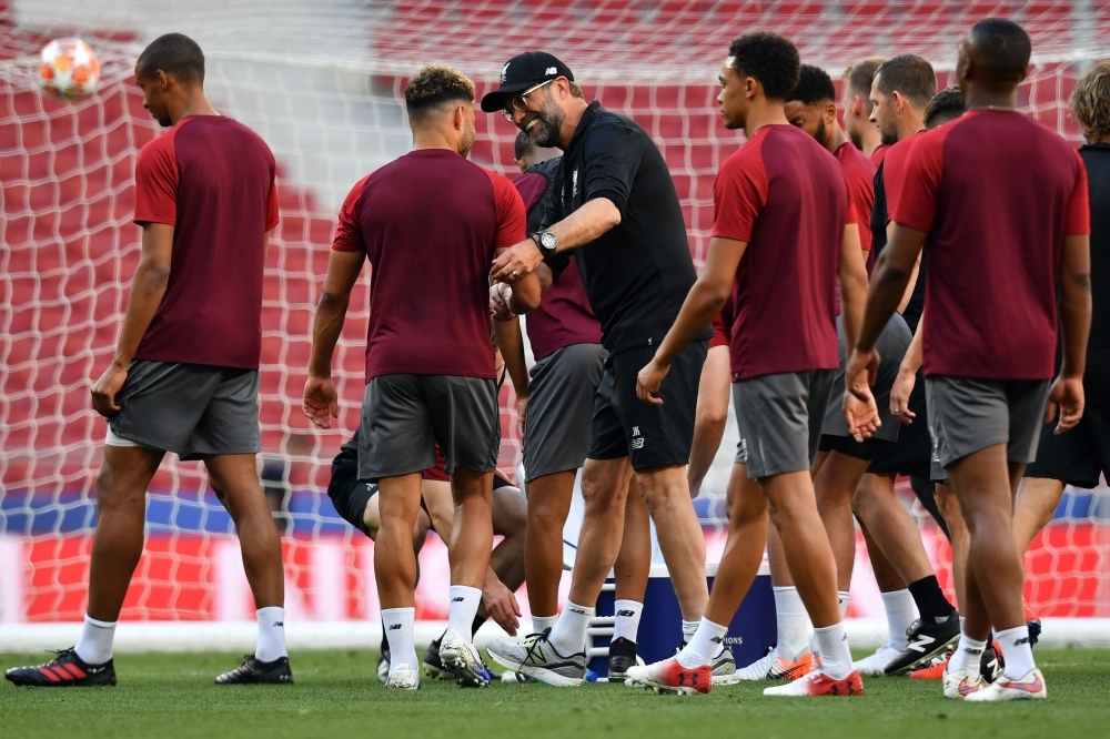 Liverpool's German coach Jurgen Klopp (C) jokes with players during a training session at the Wanda Metropolitano Stadium in Madrid on Friday on the eve of the UEFA Champions League final football match against Tottenham Hotspur. — AFP