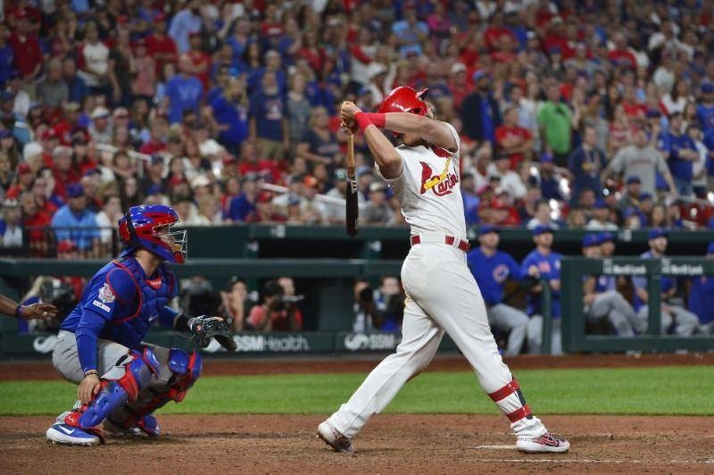 Matt Carpenter hits a game-ending, bases-loaded single in the 10th inning to send the host St. Louis Cardinals to a 2-1 victory against the Chicago Cubs on Friday night. — Reuters