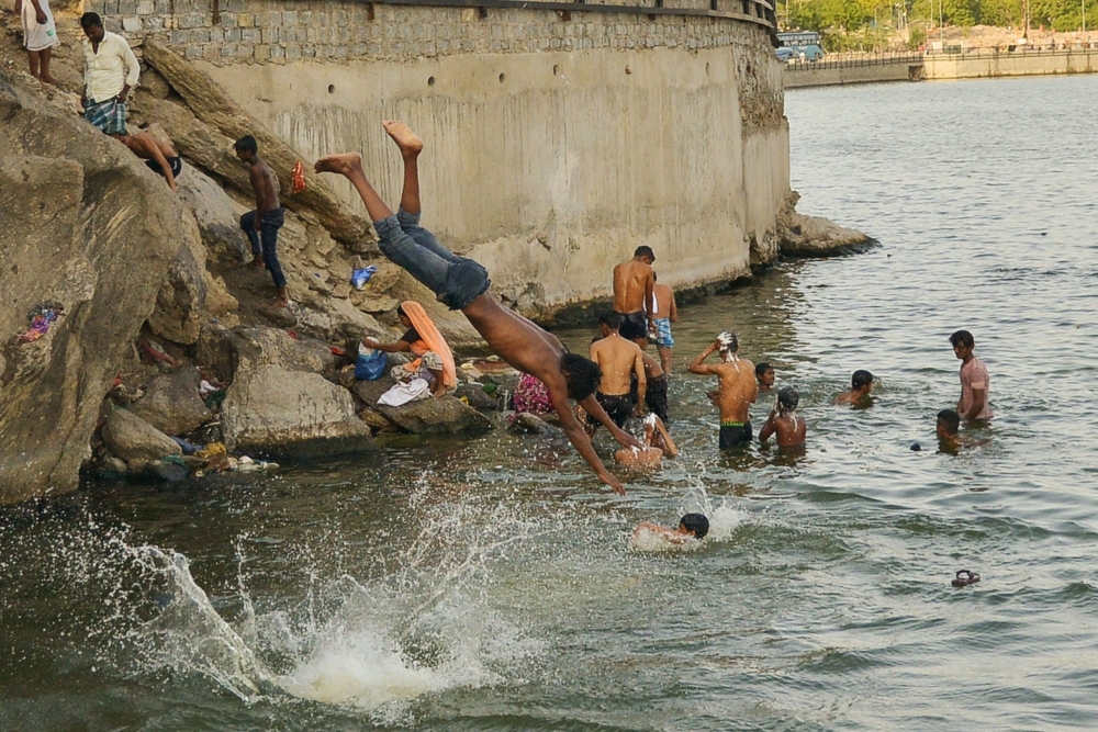 An Indian homeless child takes a bath from a hand pump as he tries to cool himself on a hot summer afternoon in Allahabad. Temperatures pushed toward 50 degrees Celsius (122 Fahrenheit) across much of India on Saturday as an unrelenting heatwave triggered warnings of water shortages and heat stroke. — AFP photos