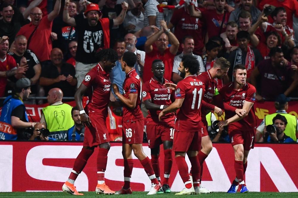 Liverpool's Belgian forward Divock Origi (L) celebrates with teammates after scoring his team's second goal during the UEFA Champions League final football match between Liverpool and Tottenham Hotspur at the Wanda Metropolitano Stadium in Madrid on Saturday. — AFP
