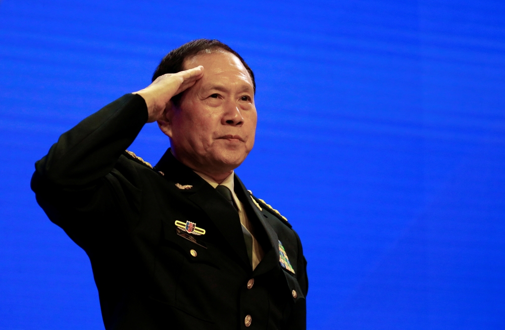 Chinese Defense Minister Wei Fenghe salutes at the IISS Shangri-la Dialogue in Singapore on Sunday. — Reuters