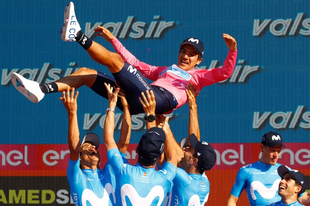 Overall race winner Team Movistar rider Ecuador's Richard Carapaz is thrown in the air by his teammates as they celebrate on the podium after stage twenty-one, the final stage of the 102nd Giro d'Italia - Tour of Italy - cycle race, a 17km individual time-trial in Verona on Sunday. — AFP