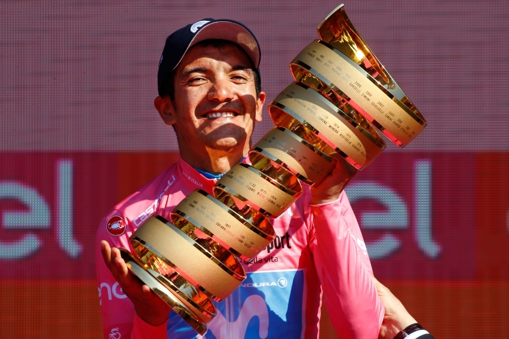 Overall race winner Team Movistar rider Ecuador's Richard Carapaz is thrown in the air by his teammates as they celebrate on the podium after stage twenty-one, the final stage of the 102nd Giro d'Italia - Tour of Italy - cycle race, a 17km individual time-trial in Verona on Sunday. — AFP