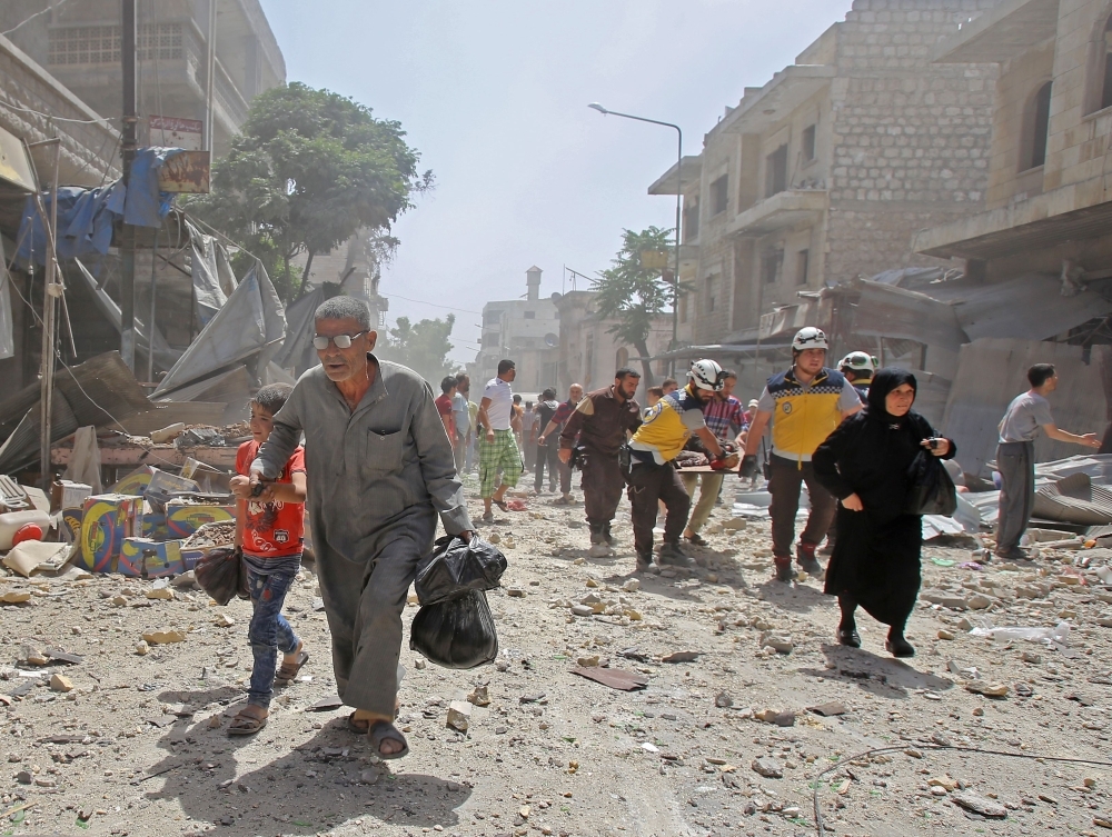Members of the Syrian Civil Defense (known as the White Helmets) carry a wounded man on a stretcher following a reported air strike on the town of Maaret Al-Numan in the  Idlib province on Monday. — AFP