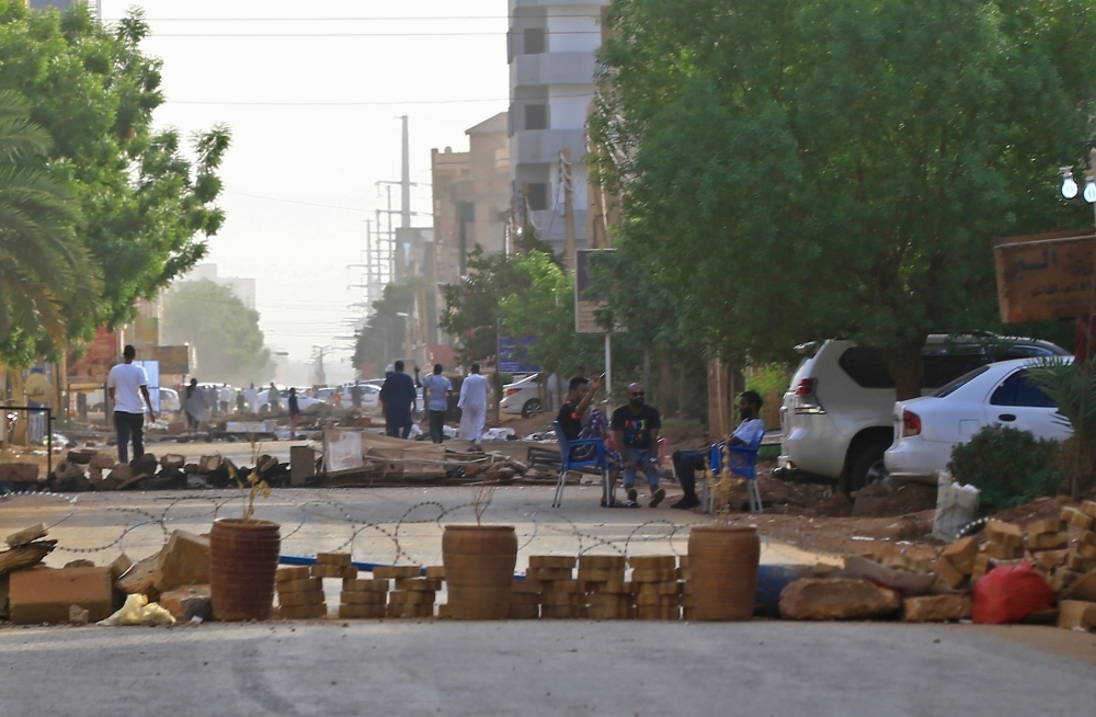 Protesters block a main street in the Sudanese capital Khartoum on Tuesday. — AFP