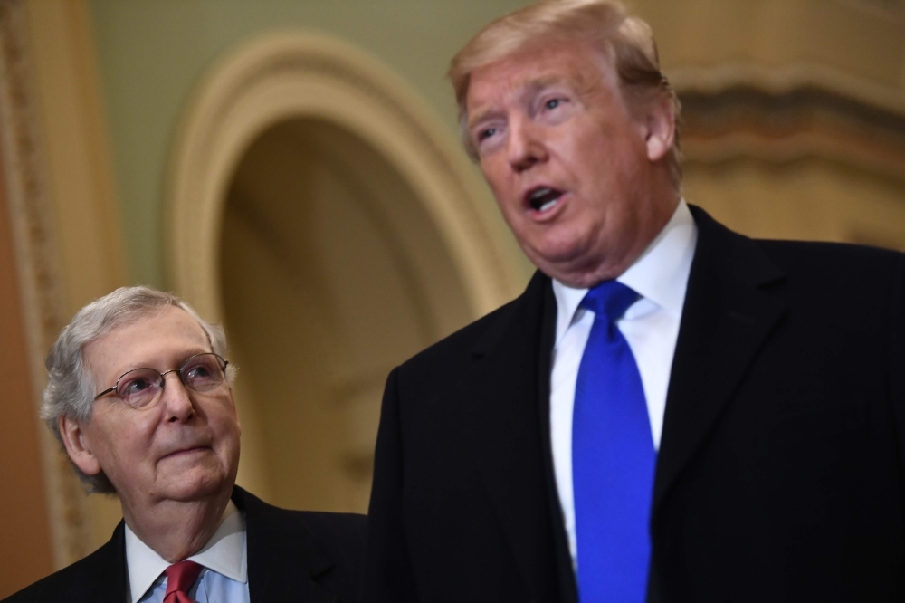 US President Donald Trump, right, speaks to the press alongside Senate Majority Leader Mitch McConnell, before joining Senate Republicans for lunch in Washington, in this March 26, 2019 file photo. — AFP