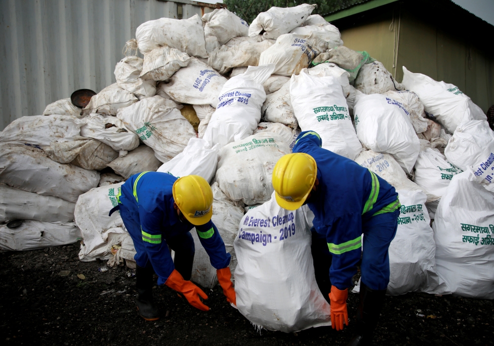 Workers from a recycling company load the garbage collected and brought from Mount Everest in Kathmandu, Nepal, on Wednesday. — Reuters