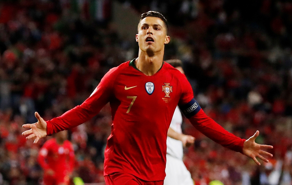 Portugal's forward Cristiano Ronaldo scores his third goal during the UEFA Nations League semifinal football matchagainst Switzerland at the Dragao stadium in Porto on Wednesday. — AFP