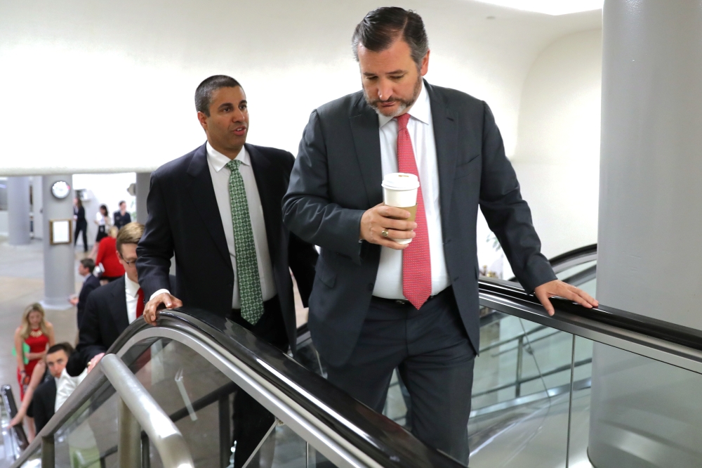 US. Federal Communications Commission (FCC) Chairman Ajit Pai speaks with Senator Ted Cruz (R-TX) as they walk through the subway system at the US Capitol in Washington, US on Wednesday. Cruz and Republican Representative Francis Rooney marked the 30th anniversary of China's bloody Tiananmen Square crackdown on Tuesday by re-introducing the 