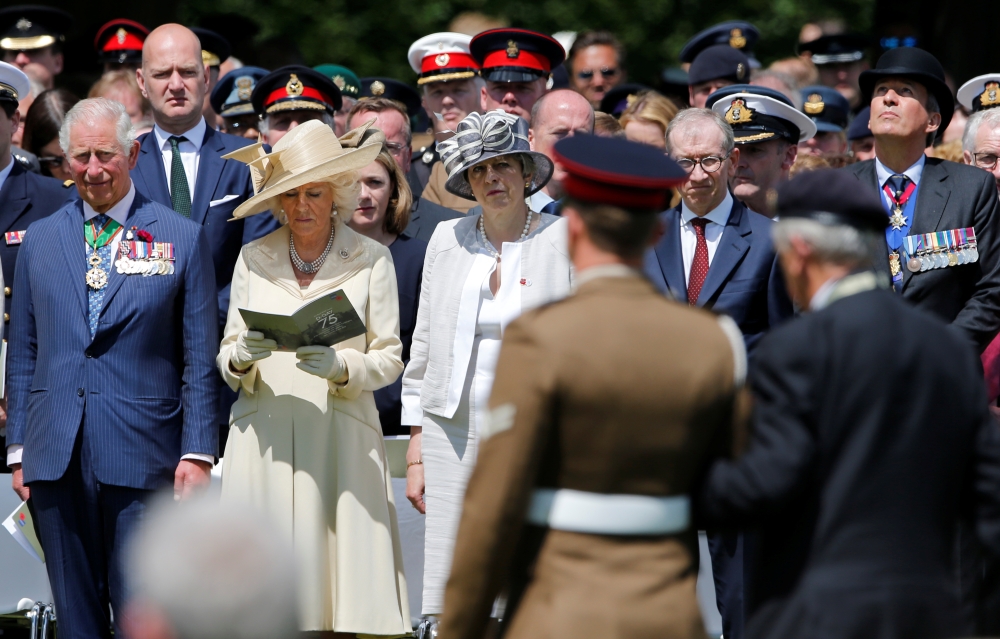 French President Emmanuel Macron helps a WWII veteran during the commemoration ceremony for the 75th anniversary of D-Day at the American cemetery of Colleville-sur-Mer in Normandy, France, Thursday. — Reuters