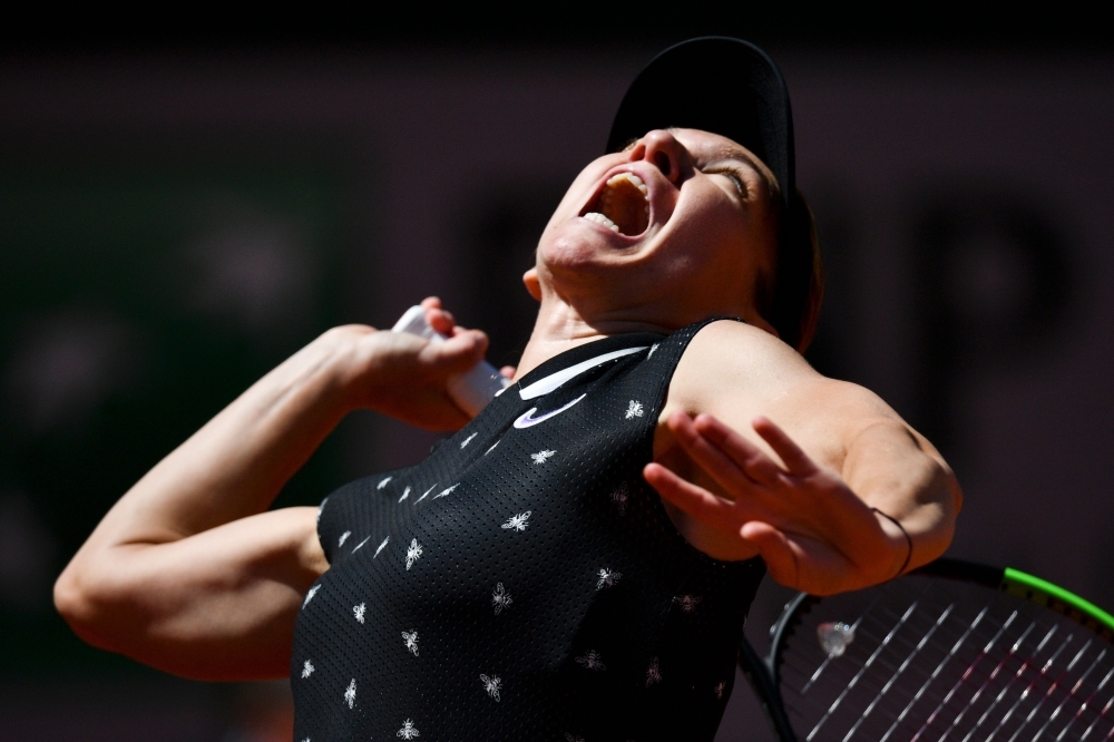 Amanda Anisimova of the US reacts during her women's singles quarterfinal match against Romania's Simona Halep, on day twelve of The Roland Garros 2019 French Open tennis tournament in Paris on Thursday. — AFP