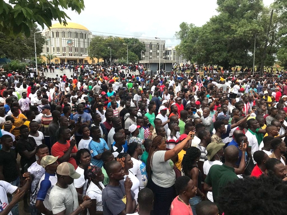 Demonstrators gather outside the Liberian Mansion in Monrovia during an anti-government march to protest at inflation and corruption on Friday. — AFP