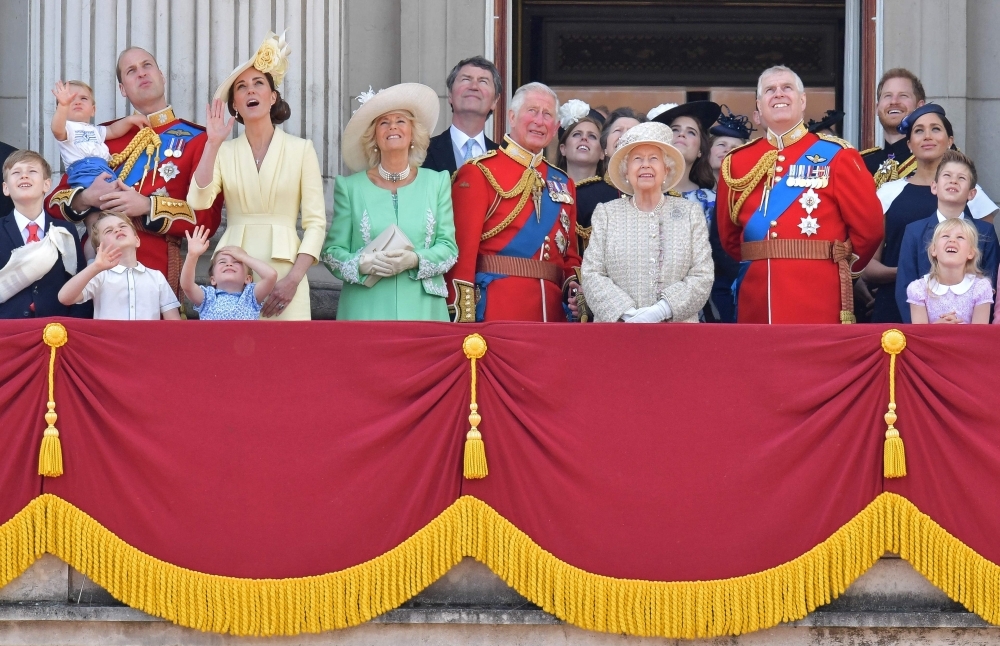 (L-R) Britain's Prince William, Duke of Cambridge holding Prince Louis, Prince George, Princess Charlotte, Britain's Catherine, Duchess of Cambridge, Britain's Camilla, Duchess of Cornwall, Vice Admiral Timothy Laurence, Britain's Prince Charles, Prince of Wales, Britain's Princess Beatrice of York, Britain's Princess Anne, Princess Royal,, Britain's Queen Elizabeth II, Britain's Princess Eugenie of York, Britain's Lady Louise Windsor, Britain's Prince Andrew, Duke of York,, Britain's Prince Harry, Duke of Sussex, Britain's Meghan, Duchess of Sussex, James, Viscount Severn and Isla Phillips stand with other members of the Royal Family on the balcony of Buckingham Palace to watch a fly-past of aircraft by the Royal Air Force, in London on Saturday. — AFP