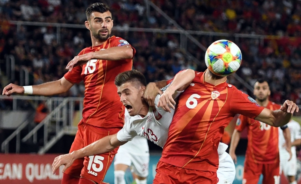 Poland's Krzysztof Piatek (C) vies with North Macedonia's Egzon Bejtulai (L) and Visar Musliu (R) during the UEFA Euro 2020 qualifying football match between North Macedonia and Poland at the Tose Proeski Arena in Skopje, on Friday. — AFP