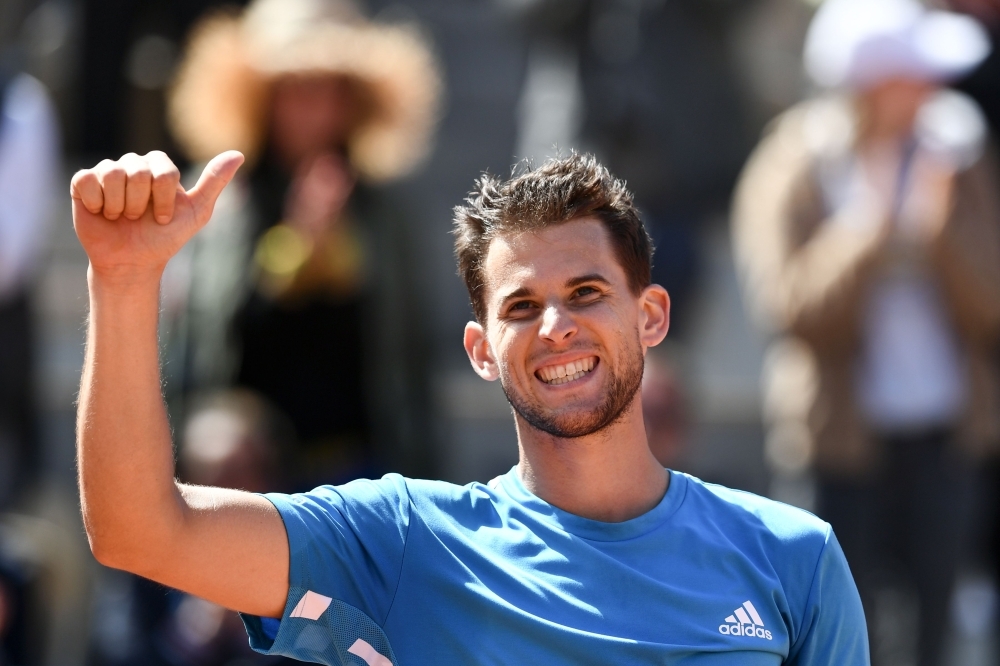 Austria's Dominic Thiem celebrates after winning against Serbia's Novak Djokovic during their men's singles semifinal match on day fourteen of The Roland Garros 2019 French Open tennis tournament in Paris on Saturday. — AFP