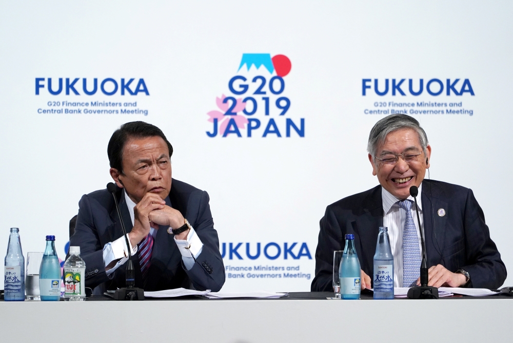 Japan's Finance Minister Taro Aso and Bank of Japan Governor Haruhiko Kuroda attend a news conference of the G20 finance ministers and central bank governors meeting in Fukuoka, Japan Sunday. — Reuters