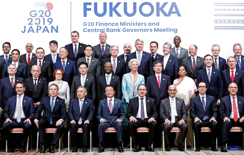 Japan's Finance Minister Taro Aso poses with delegations members for a family photo during the G20 Finance Ministers and Central Bank Governors Meeting in Fukuoka, Japan Sunday. — Reuters