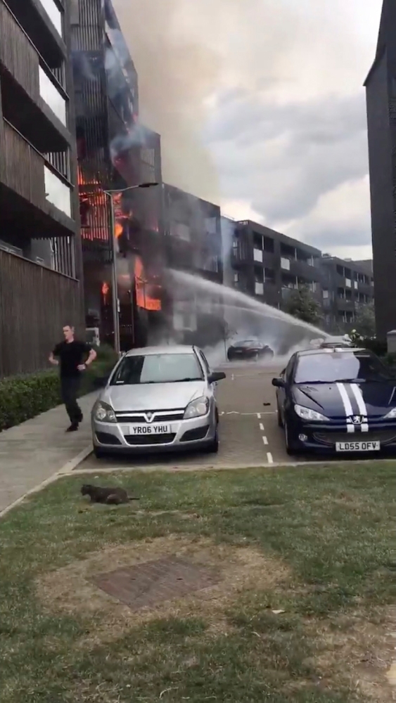 A still image taken from a video obtained on social media shows a fire in a block of flats in Barking, East London, Britain, Sunday. — Reuters