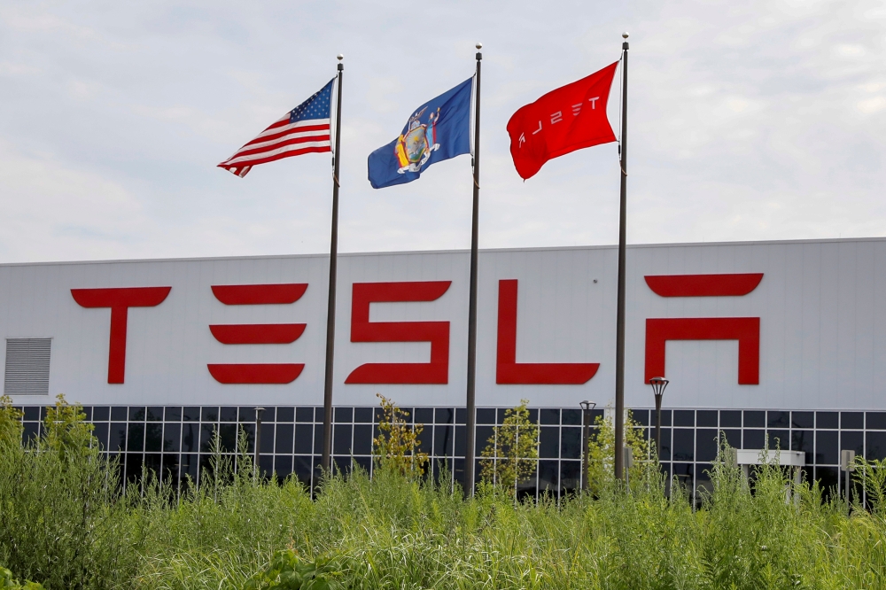 Flags fly over the Tesla Inc. Gigafactory 2, also known as RiverBend, a joint venture with Panasonic to produce solar panels and roof tiles in Buffalo, New York, US, Aug. 2, 2018, in this file photo.  — Reuters
