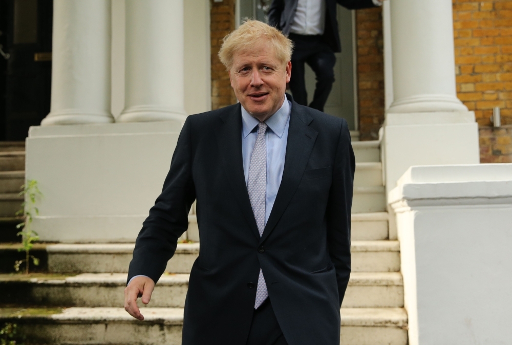 Conservative MP Boris Johnson leaves his home in London on Tuesday. — AFP