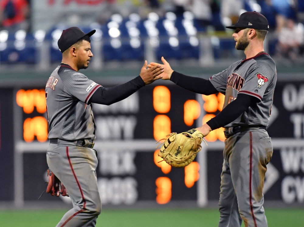 Arizona Diamondbacks third baseman Eduardo Escobar (5) and  first baseman Christian Walker (53) celebrate their win against the Philadelphia Phillies at Citizens Bank Park. — Reuters