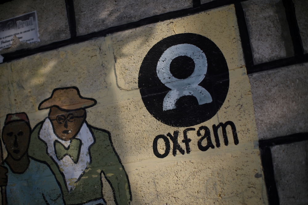 An Oxfam sign is seen on a wall in Corail, a camp for displaced people of the earthquake of 2010, on the outskirts of Port-au-Prince, Haiti, in this Feb. 17, 2018 file photo. — Reuters