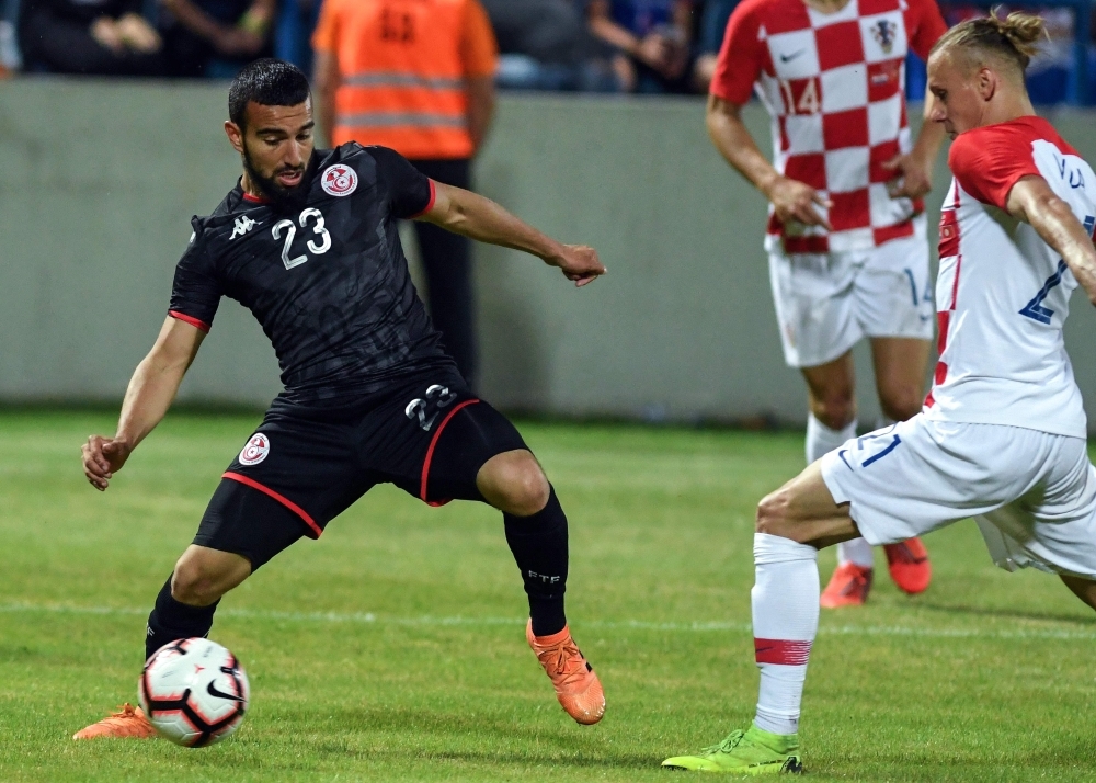 Croatia's defender Domagoj Vida, center, fights for the ball with Tunisia's forward Naim Sliti during the 2019 international friendly football match between Croatia and Tunisia in Varazdin, on Tuesday. — AFP