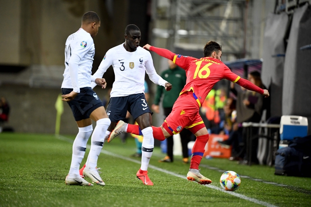 France's defender Ferland Mendy, center, vies with Andorra's forward Alex Martinez, right, during the UEFA Euro 2020 qualification football match between Andorra and France at the National stadium in Andorra La Vella, on Tuesday. — AFP