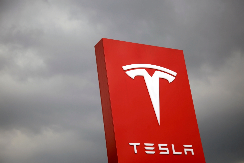 A Tesla logo on a Model S is photographed inside of a Tesla dealership in New York, US. — Reuters