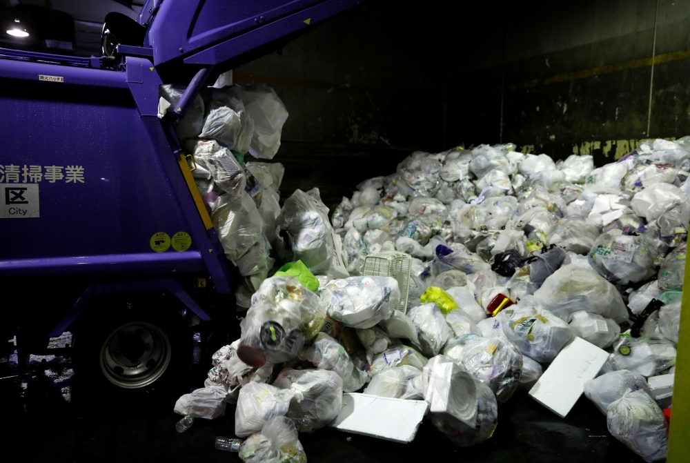 A truck unloads plastic waste for recycling at Minato Resource Recycle Center in Tokyo, Japan. — Reuters