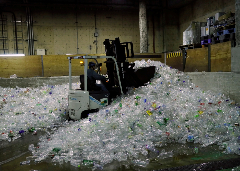 A truck unloads plastic waste for recycling at Minato Resource Recycle Center in Tokyo, Japan. — Reuters