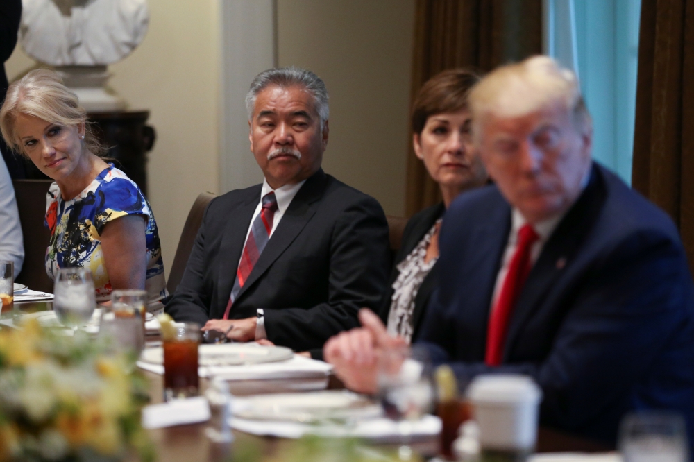 White House senior adviser Kellyanne Conway looks over at US President Donald Trump during a working lunch with governors on workforce freedom and mobility in the Cabinet Room of the White House in Washington, US, on Thursday. — Reuters