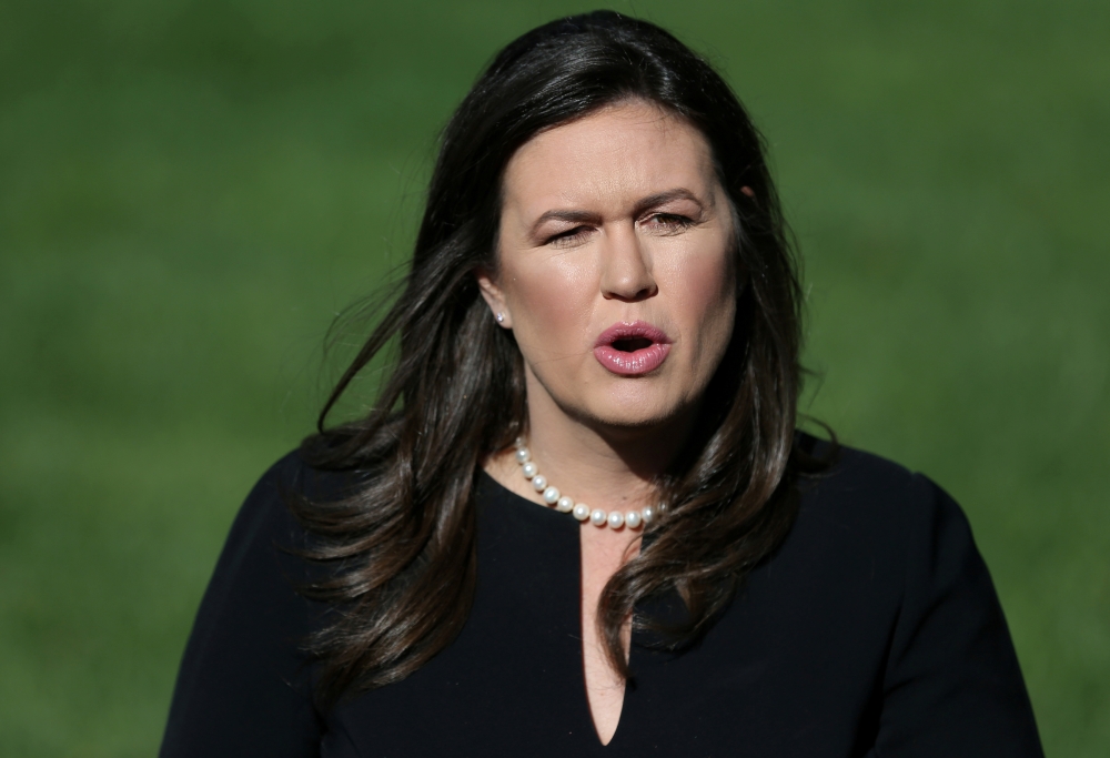 In this file photo, US President Donald Trump (L) embraces White House Press Secretary Sarah Huckabee Sanders during a Make America Great Again rally in Green Bay, Wisconsin. — AFP