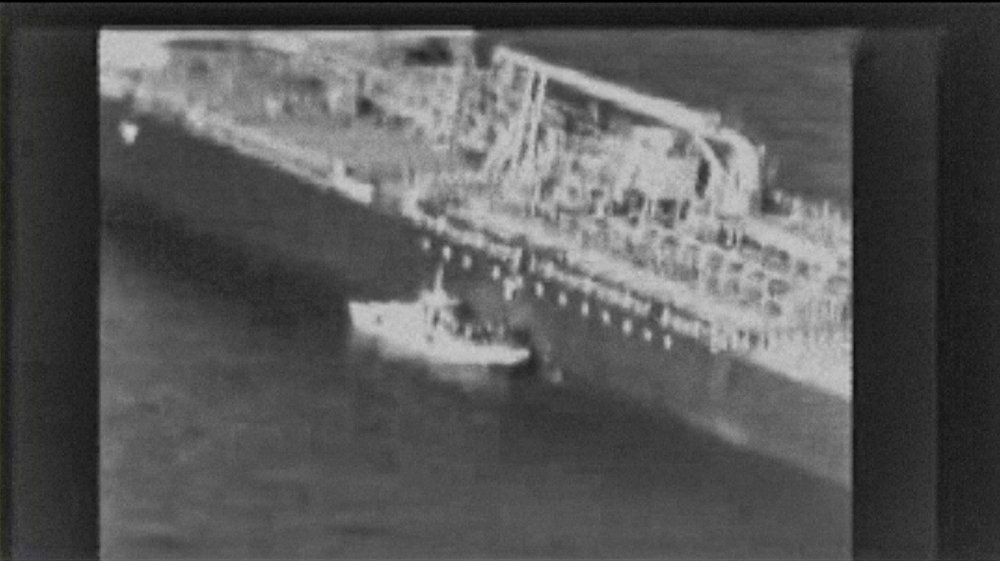 This grab taken from a video released by the US Central Command (USCENTCOM) on Friday, reportedly shows an Iranian navy patrol boat in the Gulf of Oman approaching the Japanese operated methanol tanker Kokuka Courageous and removing an unexploded mine. — AFP