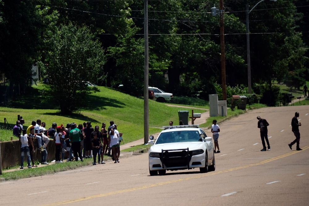 A young man walks in front of a police patrol parked in front of a high school a day after violent clashes between police and protesters broke out on streets overnight in Memphis, Tennessee, US, Thursday. — Reuters