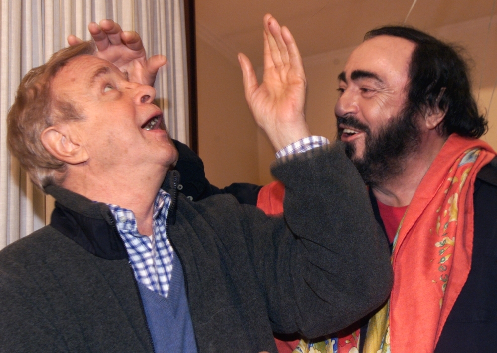 In this file photo taken on Jan. 11, 2000 Italian tenor Luciano Pavarotti (R) jokes with Italian Director Franco Zeffirelli during a press conference in Rome, three days before the first presentation of Giacomo Puccini's 