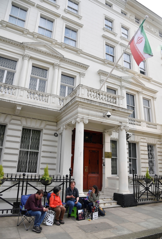 Richard Ratcliffe, the husband of jailed British-Iranian aid worker Nazanin Zaghari-Ratcliffe speaks with supporters as he stages a vigil and goes on hunger strike outside of the Iranian embassy in London on Saturday. — Reuters