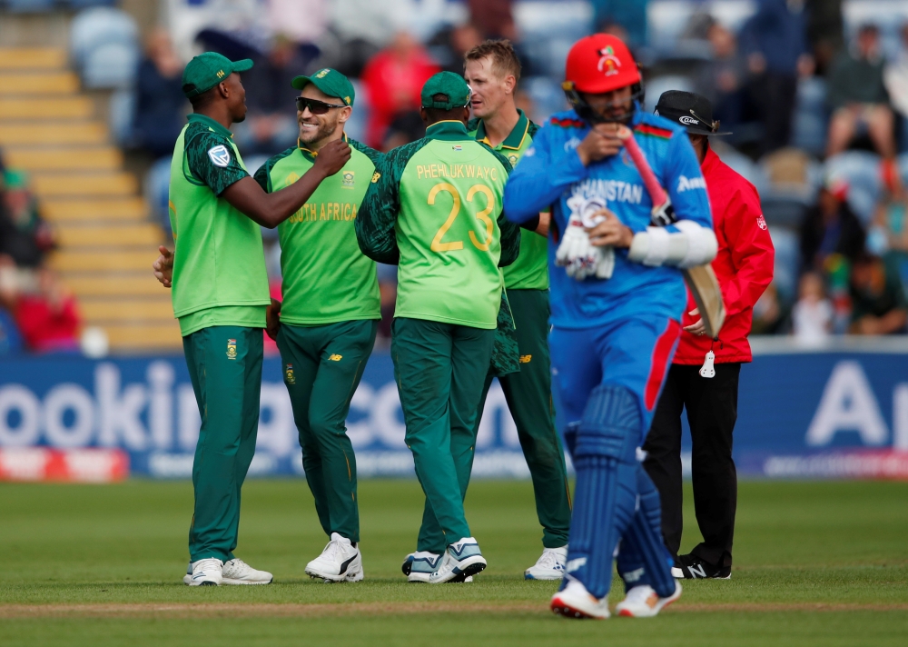 South Africa's Chris Morris celebrates with Faf du Plessis and teammates after taking the wicket of Afghanistan's Hamid Hassan during the ICC Cricket World Cup match at Cardiff Wales Stadium, Cardiff, Britain, on Saturday. — Reuters