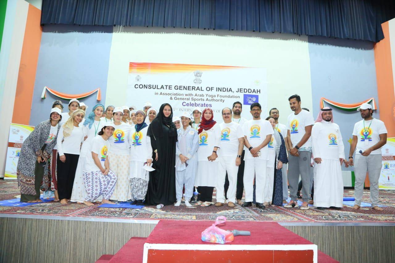 Dr. Ausaf Sayeed and Noor Rahman Sheikh pose with yoga enthusiasts. — Courtesy photos