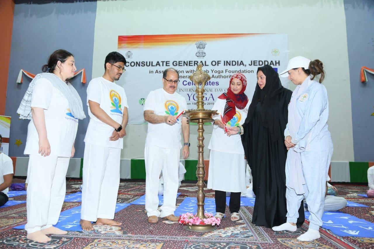 Dr. Ausaf Sayeed and Noor Rahman Sheikh pose with yoga enthusiasts. — Courtesy photos