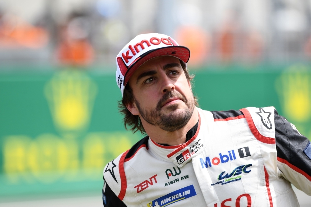Toyota TS050 Hybrid LMP1 of Japanese's driver Kazuki Nakajima (R) Spain's driver Fernando Alonso (2L) and Switzerland's driver Sebastien Buemi (2R) celebrates on podium after winning in the 87th edition of the 24 Hours Le Mans endurance race on Sunday, at Le Mans northwestern France. — AFP 
