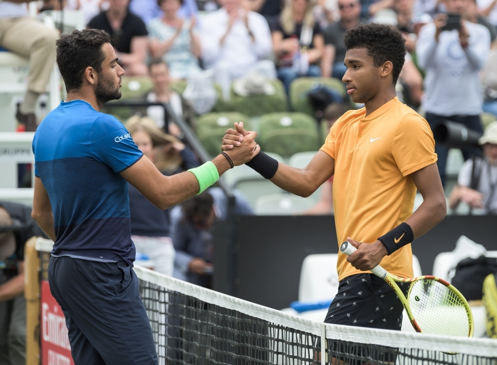 Italy's Matteo Berrettini poses with his trophy next to the full electric Mercedes-Benz EQC Edition 1886 that he won after defeating Canada's Felix Auger-Aliassime in their final at the ATP Mercedes Cup tennis tournament in Stuttgart, southwestern Germany, on Sunday. — AFP