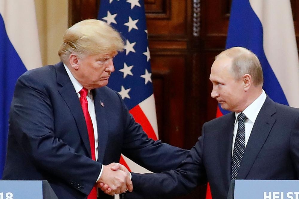 US President Donald J. Trump (L) and Russian President Vladimir Putin (R) shake hands during a joint press conference in the Hall of State at Presidential Palace following their summit talks, in Helsinki, Finland, in this 16 July 2018, file photo.
